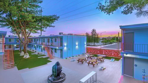 A courtyard with a fountain and picnic tables at The Neon Apartments, Las Vegas, NV, 89106