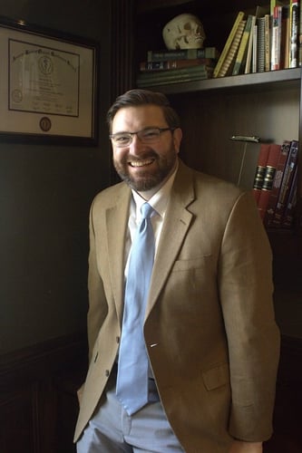 Dr. Olsen posing inside office