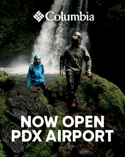 People hiking in rain gear.