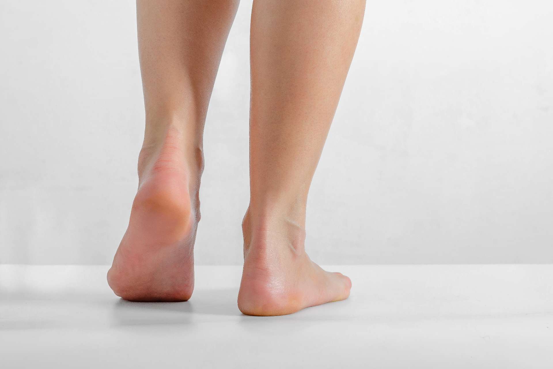 person with flat feet standing bare foot
