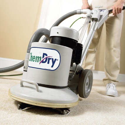 Chem-Dry carpet cleaning powerhead pushed by a technician.