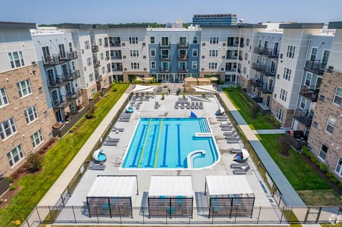 an aerial view of an apartment building with a swimming pool at Arden of Warrenville Apartments, Warrenville, Illinois