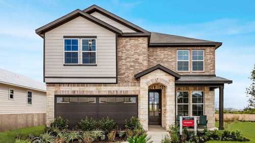 two-story family home with tan brick exterior