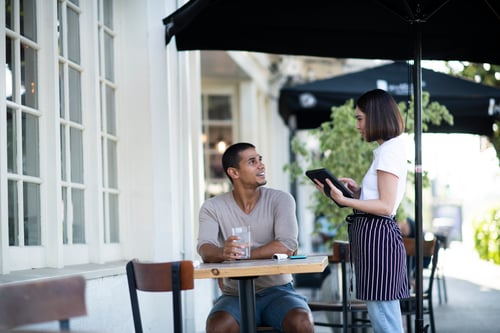 Waiter taking an order at a Cafe