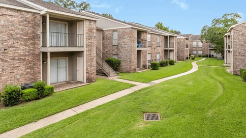 Apartment buildings on green, lush grounds