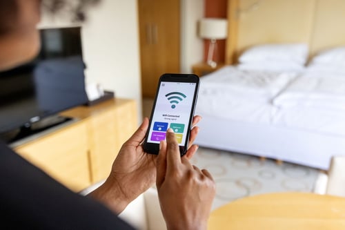 Person in room checking wifi connection on phone