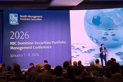 Professional on stage in front of a large audience at the RBC Dominion Securities Portfolio Management Conference.