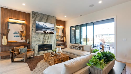 Open-concept great room in the Gates home design with stacking patio doors to covered patio