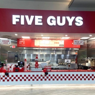Exterior photograph of the Five Guys restaurant inside Annapolis Mall in Annapolis Maryland.