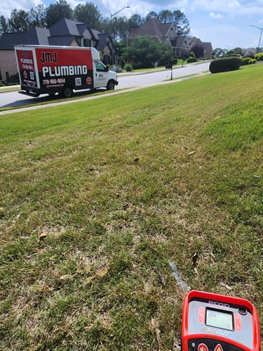 JMJ Plumbing branded service truck parked at a residential job site
