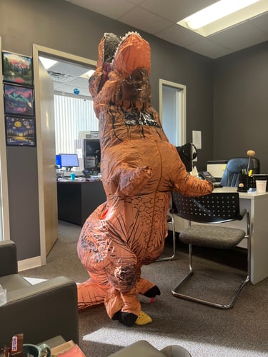 Team Member dressed in an inflatable dinosaur