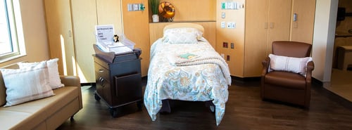 Closer photo of the birthing bed and recliner, as well as bassinet for when your baby arrives.