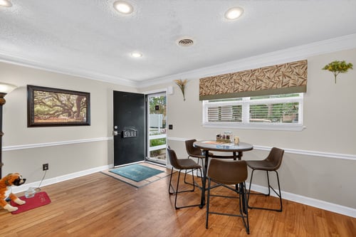 A dining room with a table and chairs.