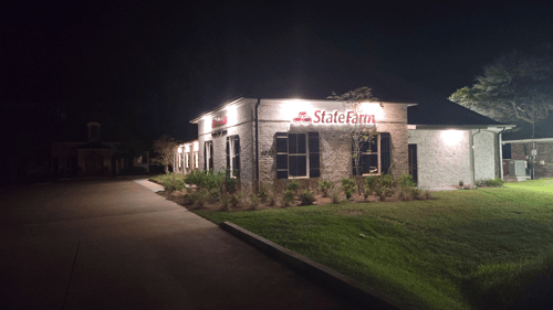 nighttime photo of the exterior of the Jake Jacobs - State Farm Insurance Agent office building with the State Farm wordmark lit up