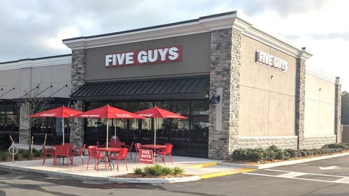 Exterior photograph of the Five Guys restaurant at 8124 Little Road in New Port Richey, Florida.