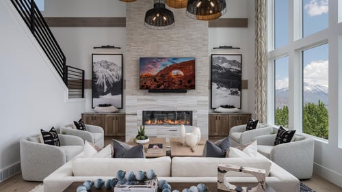 Spacious great room with large windows and cozy fireplace