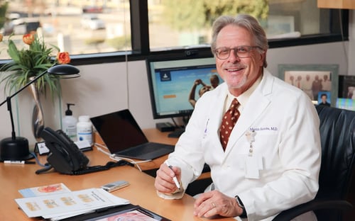 Dr. Bastuba in his office smiling