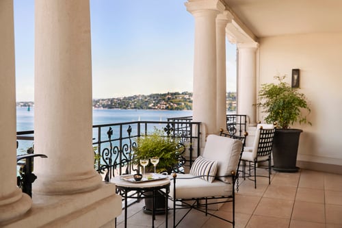 Private terrace with seating area and panoramic lake and city views from The Woodward Geneva suite.