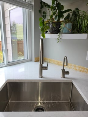 a newly installed gooseneck faucet and instant hot water heater dispenser