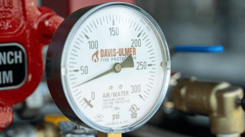 Part of sprinkler system with Davis-Ulmer Fire Protection logo on it