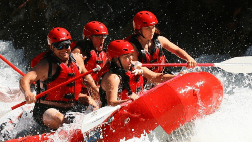 group of people white water rafting