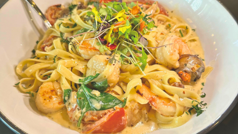 Shrimp and scallop Florentine fettuccine with spinach, roasted tomatoes, shallots, basil, mushrooms, and white wine cream sauce at Giordano’s in Kennett Square, PA.