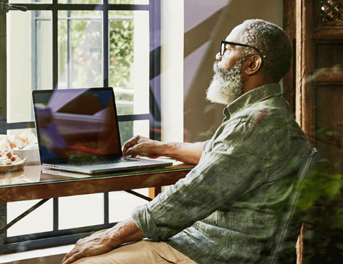 older man looking at laptop computer