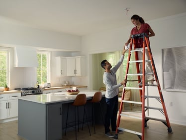 Couple installing an alarm