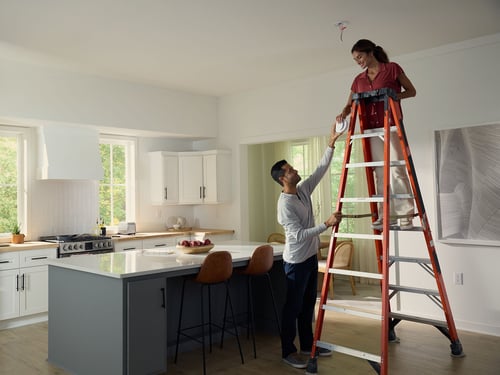 Couple installing an alarm