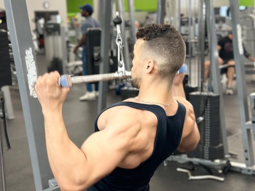 Man working out with strength training equipment at 10GYM in Jenks