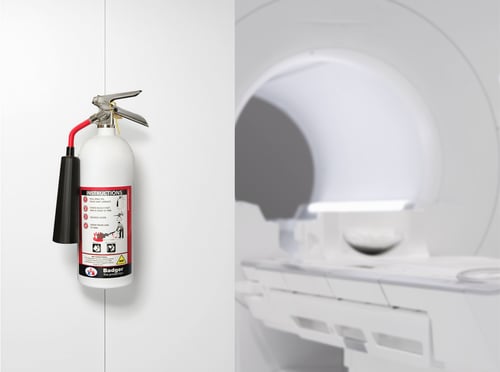 A Non-magnetic fire extinguisher next to an MRI machine
