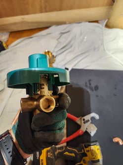A bluefrog Plumber examining a shower valve in Northeast Portland