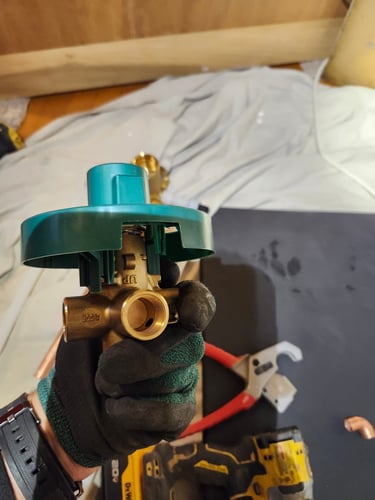 A bluefrog Plumber examining a shower valve in Northeast Portland