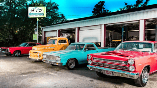 exterior view of shop various colored hot rods