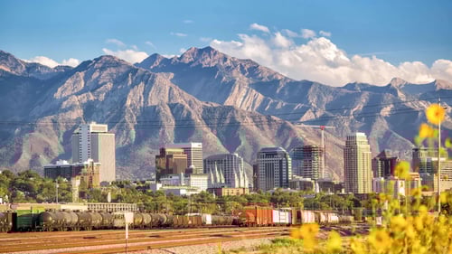 group of buildings in front of mountains