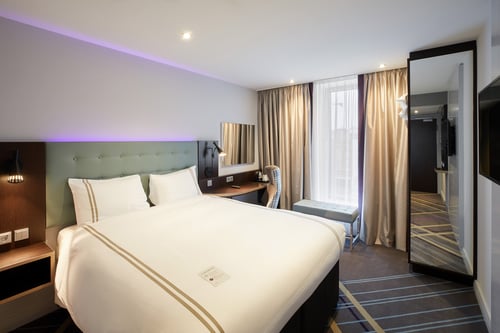 Premier Inn Germany room with double bed and mirror