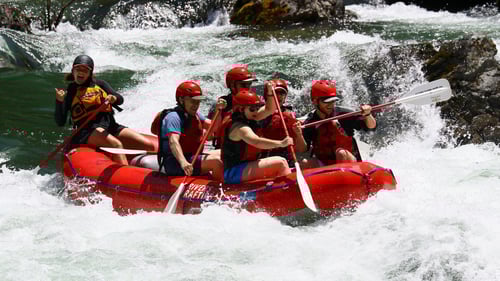 large group of people riding rapids