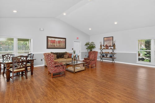 A living room with wooden floors and furniture.