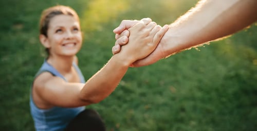 woman grabbing another hand