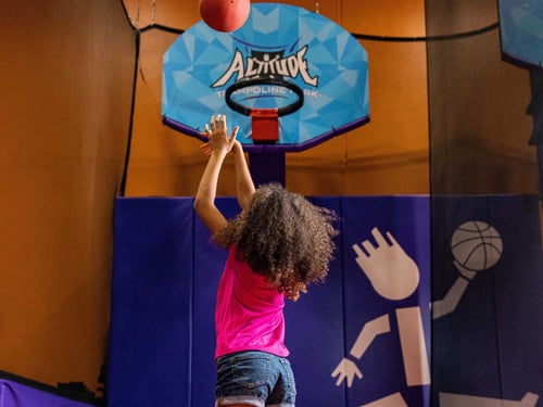 Child shooting a basketball at Altitude Trampoline Park in Pueblo.