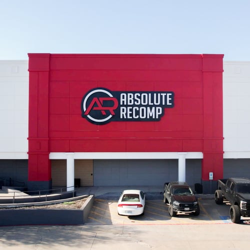Exterior of Absolute Recomp, the best gym in Fort Worth with bold red facade and large gym sign.