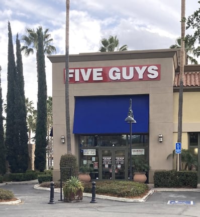 Exterior photograph of the Five Guys restaurant at 10060 Alabama Street in Redlands California.