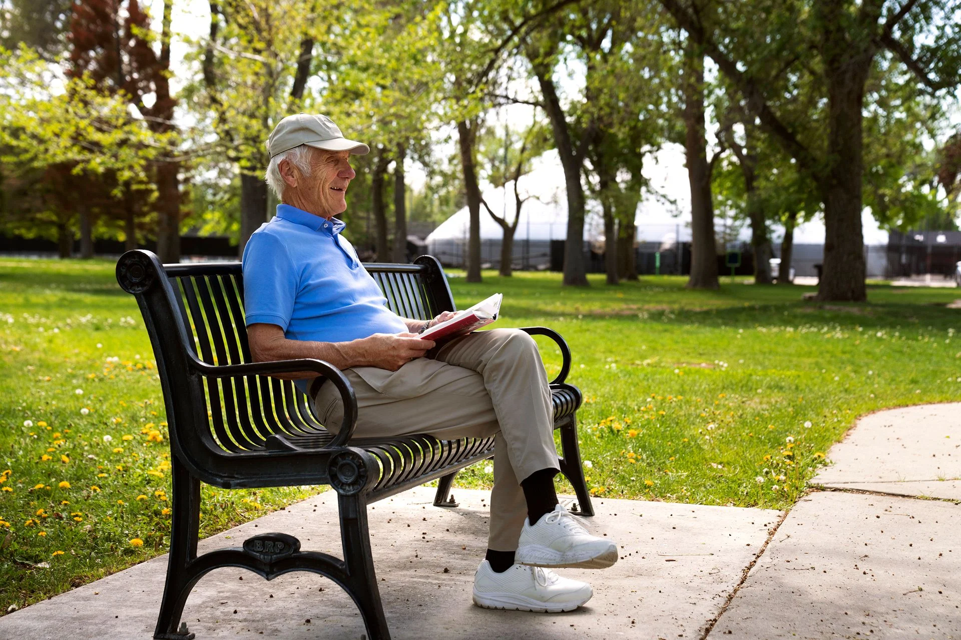 elderly man sitting on park bench