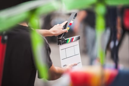 blurred foreground with focus on clapperboard being used in the background