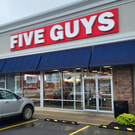 Exterior photograph of the Five Guys restaurant at 8248 Transit Road in Amherst New York.