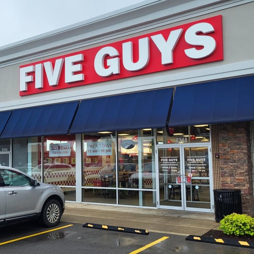 Exterior photograph of the Five Guys restaurant at 8248 Transit Road in Amherst New York.