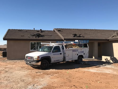 Masco & Sons service truck at residential site for AC installation