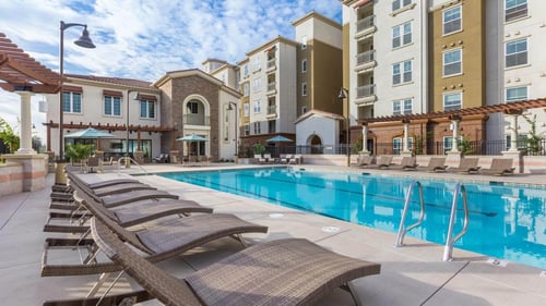 The exterior view of Amalfi apartments showing a modern building with a pool area.