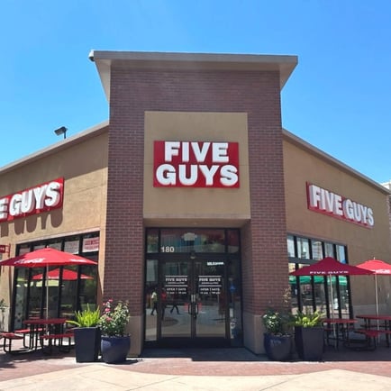 Exterior photograph of the Five Guys restaurant at 180 Paseo del Centro in Fresno California.