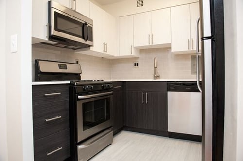 Modern kitchen upgrades in select units with updated appliances, flooring, cabinets, and countertops.
